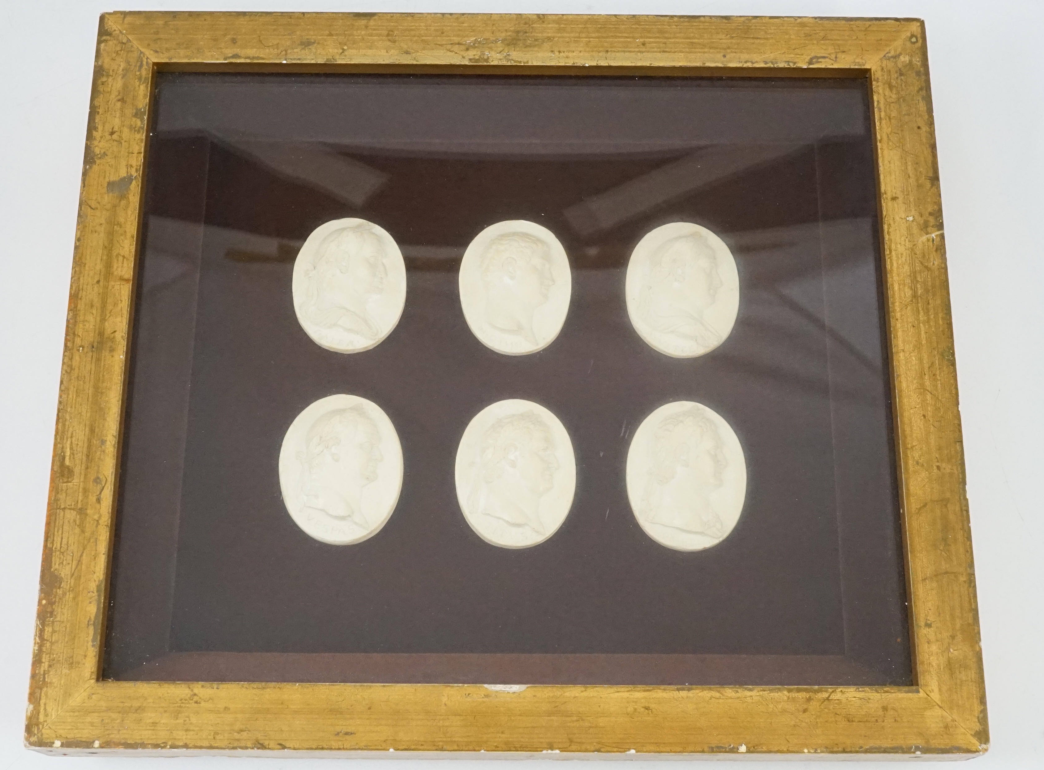 Three framed sets of simulated plaster classical gems, largest overall 30 x 30cm